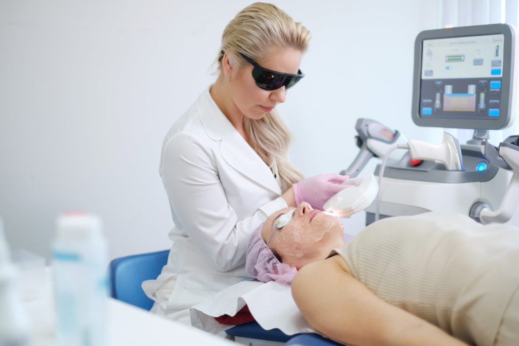 Laser hair removal treatment. Doctor holding. Clinic skin care procedure. Medical dermatology photo equipment. People epilation device. Cosmetology technology salon epilation. Body aesthetic | Beauty at First Sight Med Spa in Chicago, Illinois