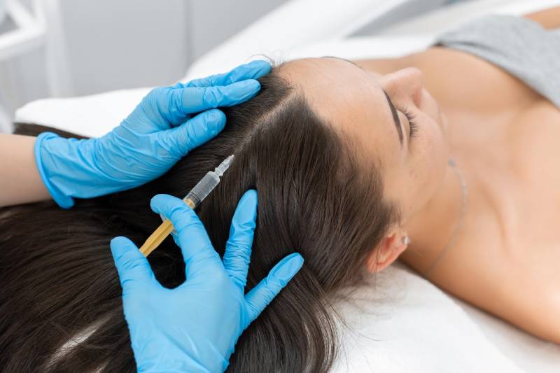 a person injecting a hair