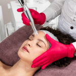 a woman receiving a facial treatment
