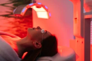 a woman lying on a bed with red lights